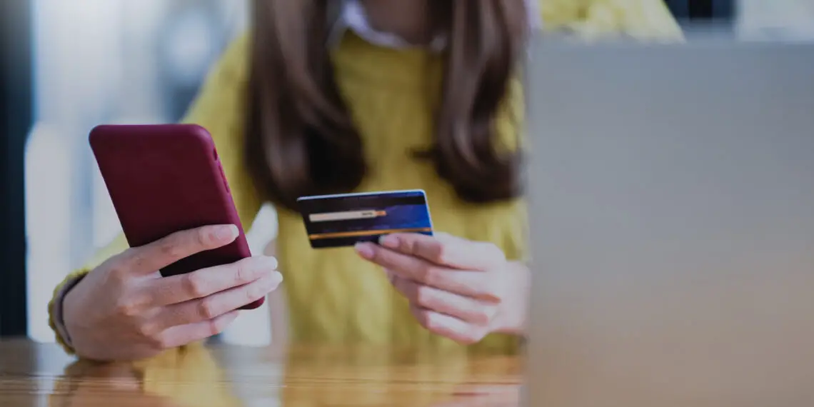 Young woman paying online by smartphone and credit card, Online shopping, Online banking.