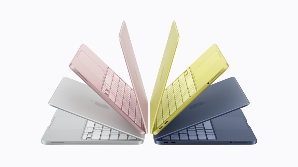 Mehrere farbige Apple MacBook Air Modelle sind auf weißem Hintergrund aufgefächert und zeigen Gehäuse und Tastaturen in Silber, Rosa, Gelb und Blau.